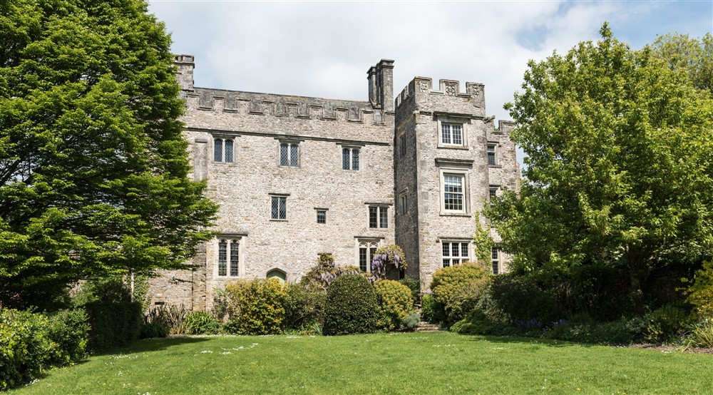 View across the lawn to the house at Oak Cottage in Bridport, Dorset