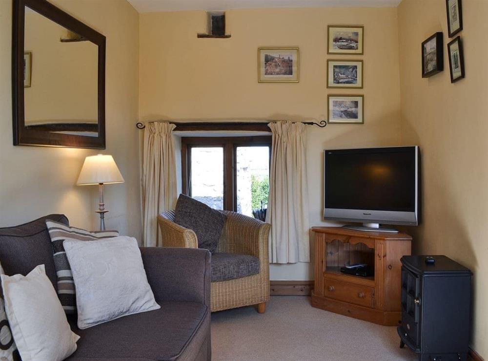 Living room with TV at Oak Cottage in Trefonen, near Oswestry, Shropshire