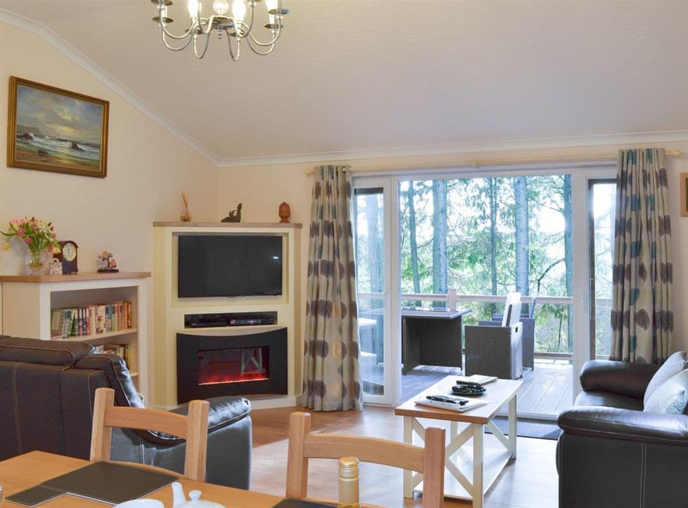 Comfortable living area with doors to the veranda at Oak Lodge in Clatworthy, near Williton, Somerset