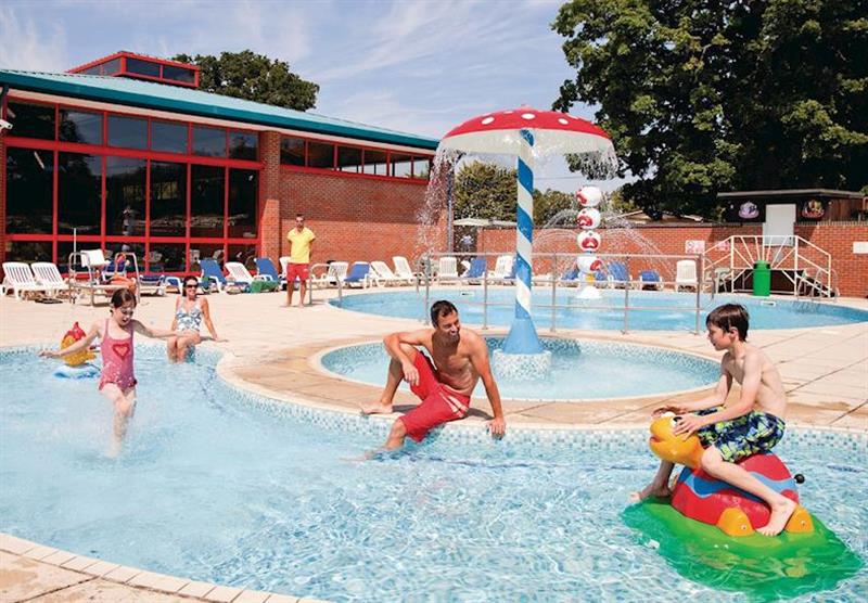 Outdoor swimming pool with water jets at Oakdene Forest Park in St Leonards, Ringwood, Hampshire
