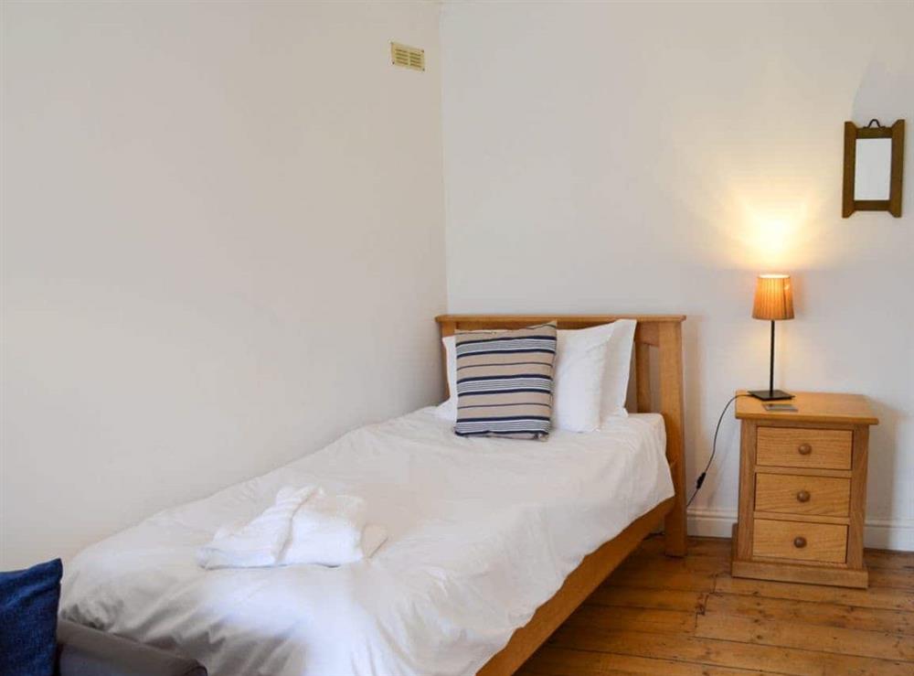 The single bedroom has a lovely wooden floor at Oaken Cottage in Mousehole, Penzance, Cornwall., Great Britain