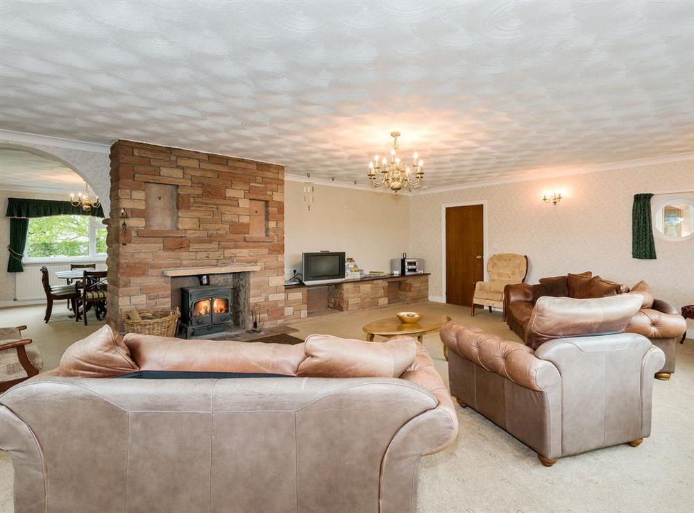 Grand living room with wood burner at Oaklands in Langrigg, near Cockermouth, Cumbria