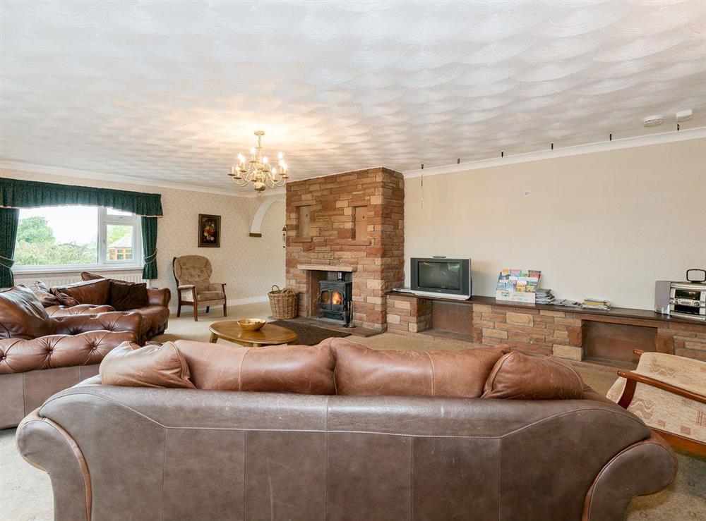 Spacious living area with wood burner at Oaklands in Langrigg, near Cockermouth, Cumbria