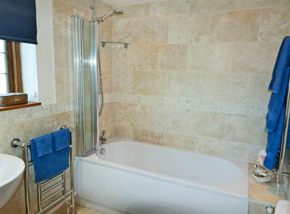Bathroom with shower over bath at Oast Cottage in Herstmonceux, near Hailsham, East Sussex