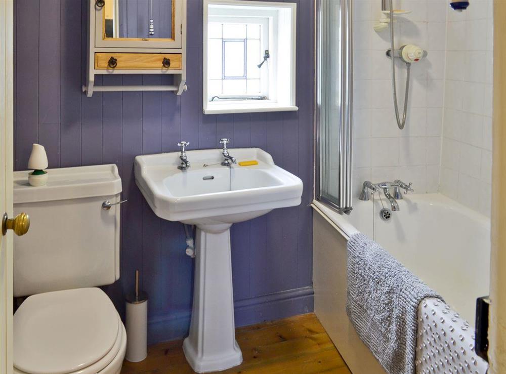 Family bathroom with shower over bath at Ocean Cottage in Whitby, North Yorkshire