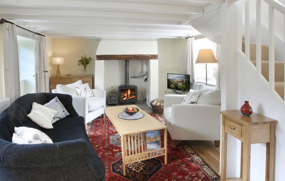 Sitting room with separate dining area at Odd Nod Cottage, Coombe Keynes