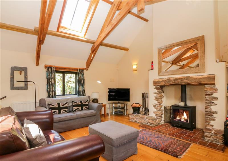 Living room with a wood burner at Ohope Barn, Ringmore, Devon
