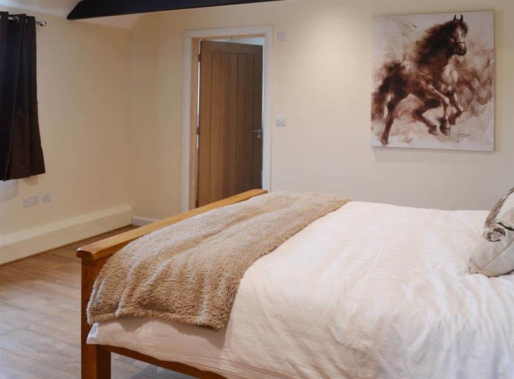 Beamed double bedroom with en-suite shower room at Horseshoe Cottage, 