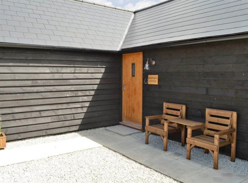 Courtyard entrance with outdoor seating at Horseshoe Cottage, 