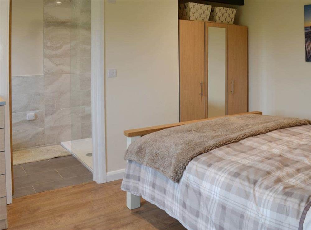 Comfortable double bedroom and en-suite shower room at Saddlers Cottage, 