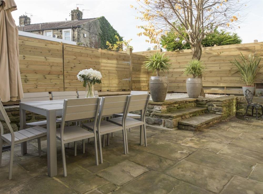 Enclosed rear courtyard with outdoor furniture at Old Chapel House in Barnoldswick, Lancashire