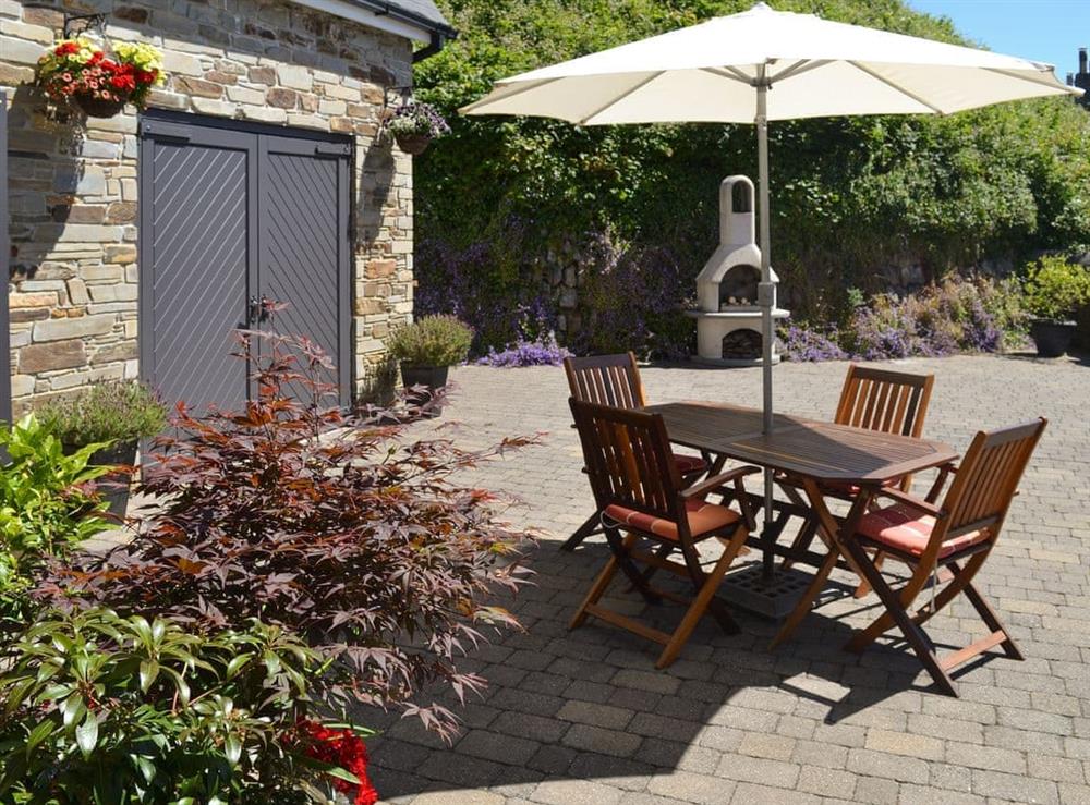 Enclosed patio with outdoor furniture and BBQ