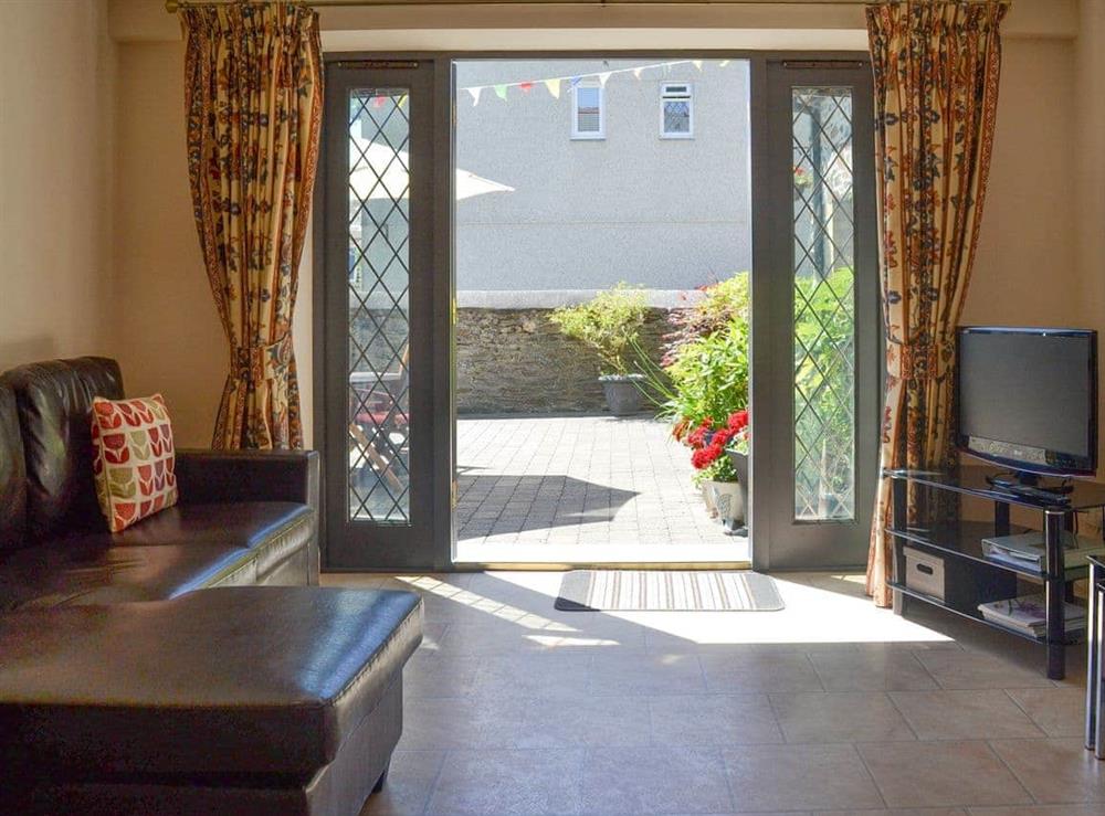 Open plan living space with French doors to patio at Old Church School in Plympton, near Plymouth, Devon