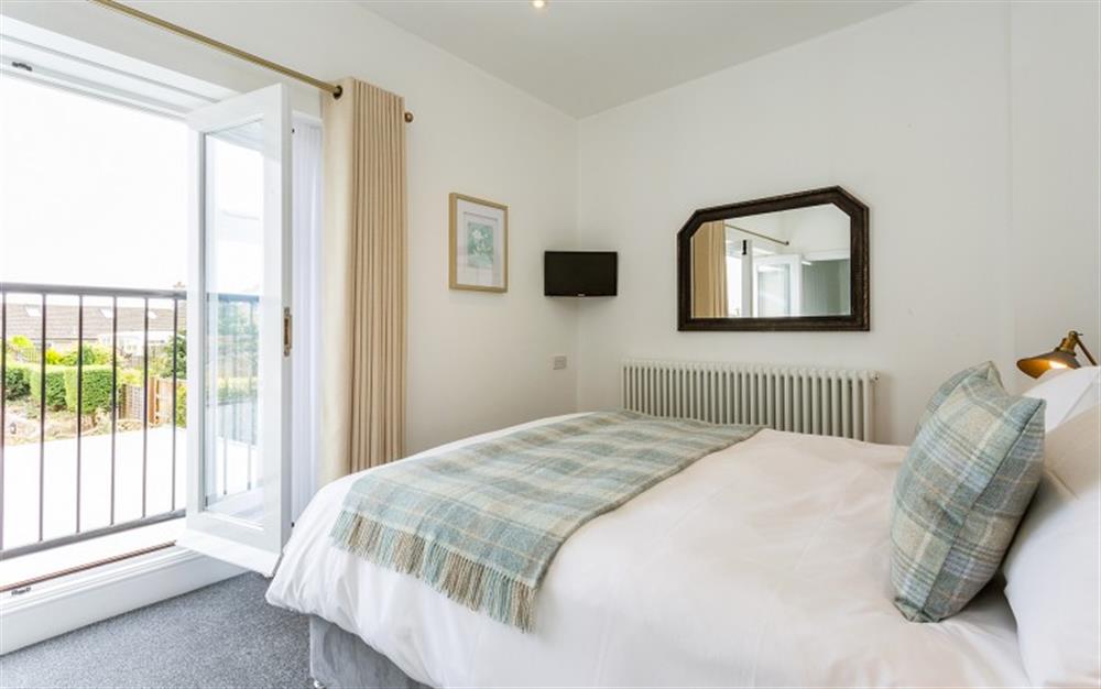Master bedroom with Juliette balcony and countryside views at Old Cider Press in Colyton