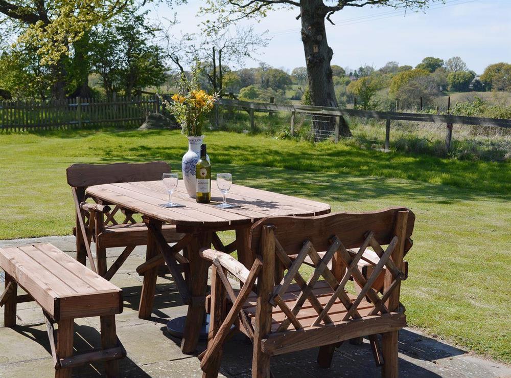 The table and chairs outside make a great place for alfresco dining at Old Dairy Barn in Playden, near Rye, East Sussex