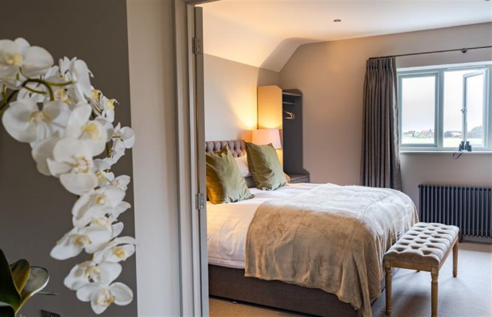 First floor: Master bedroom with king-size bed at Old Farm, Thornham near Hunstanton