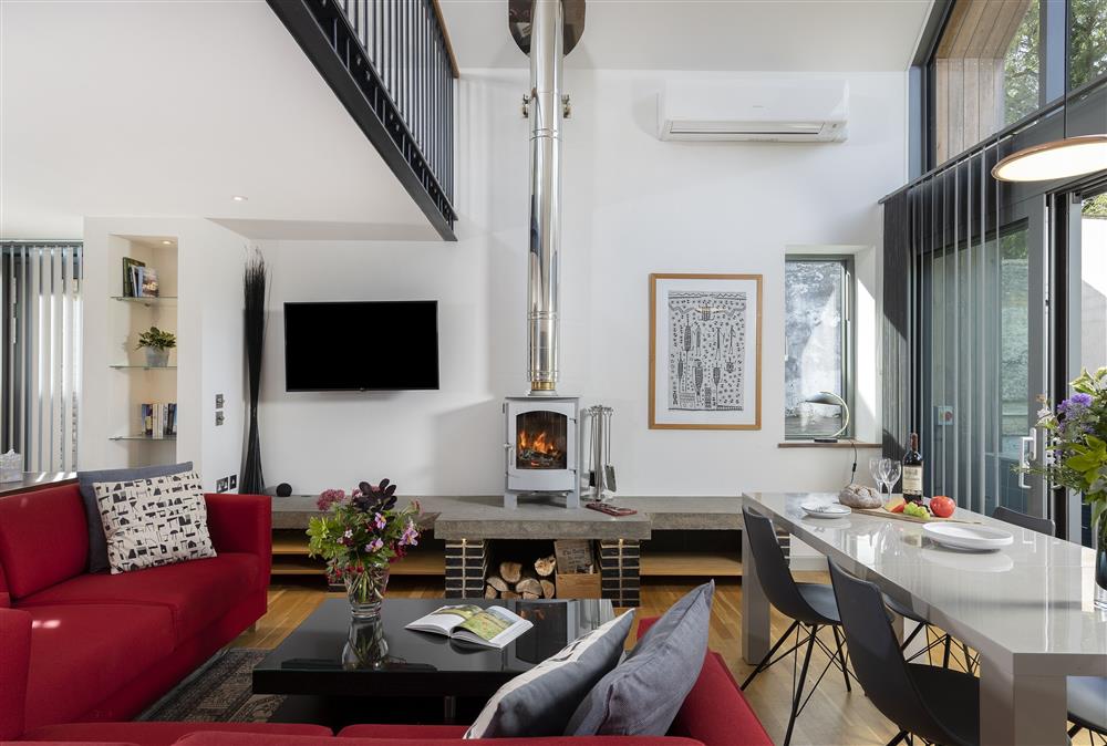 Sitting room with dining table and chairs and wood burning stove