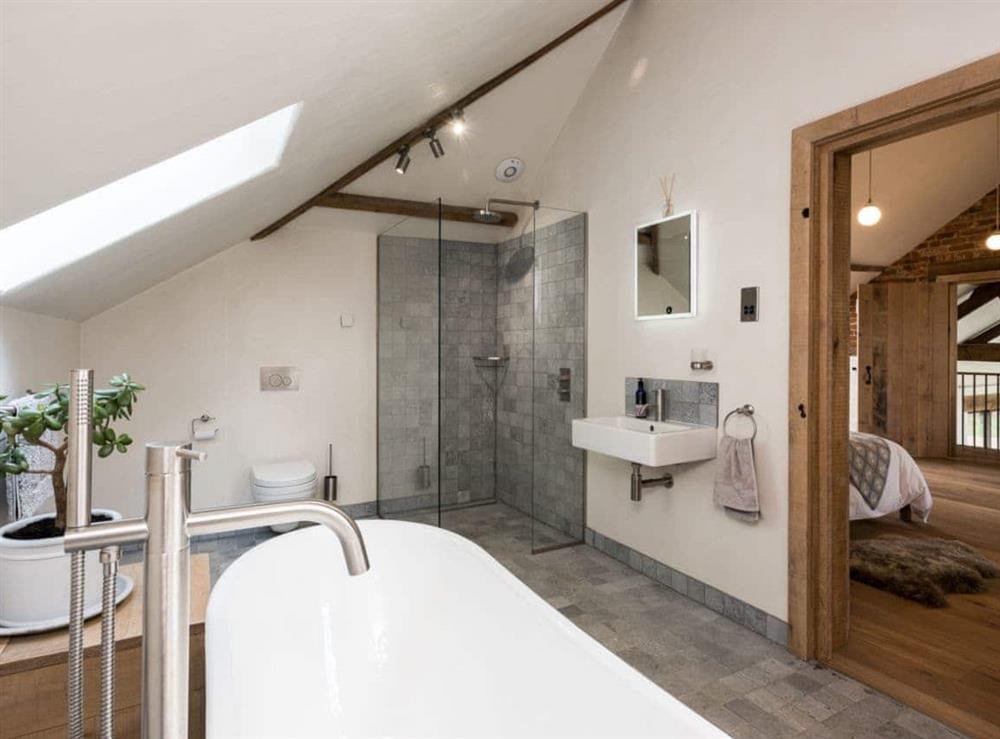 Bathroom with stand alone bath & walk- in shower at Old Hall Farm Barn in Kerdiston, near Norwich, Norfolk