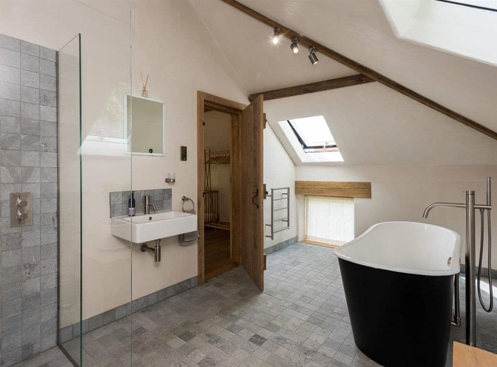 Bathroom with walk-in shower & stand alone bath at Old Hall Farm Barn in Kerdiston, near Norwich, Norfolk