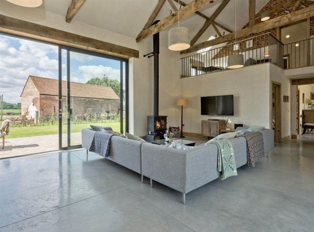 Living room with vaulted ceiling & patio doors at Old Hall Farm Barn in Kerdiston, near Norwich, Norfolk