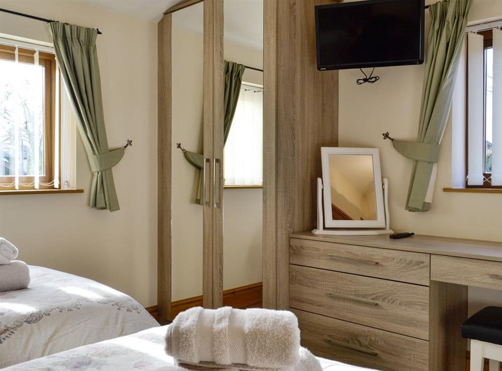 Ample storage within twin bedroom at King Offa Lodge, 