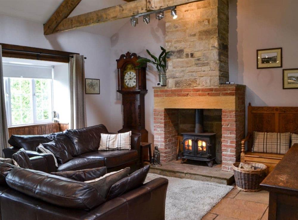 Cosy lounge with wood burning stove & wood beamed ceiling at Old Kielder Castle Cottage in Kielder, near Bellingham, Northumberland