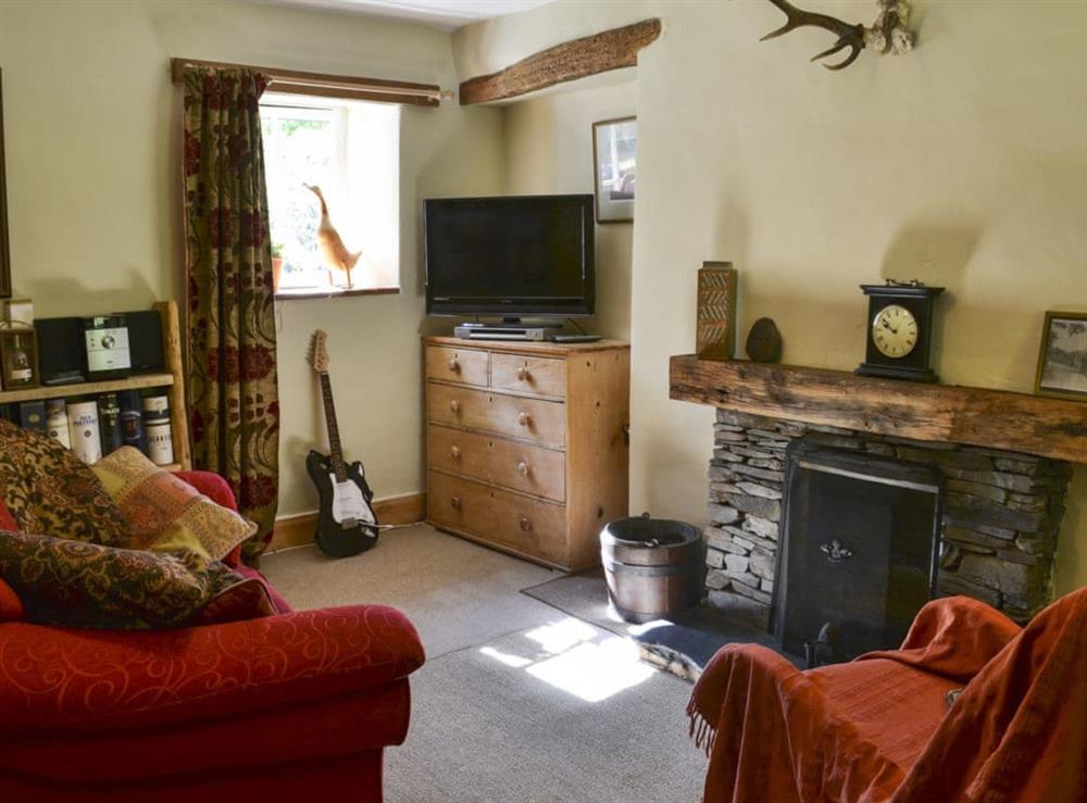 Cosy living room with  open fire at Old Mill Cottage in Duror, near Appin, Highlands, Argyll