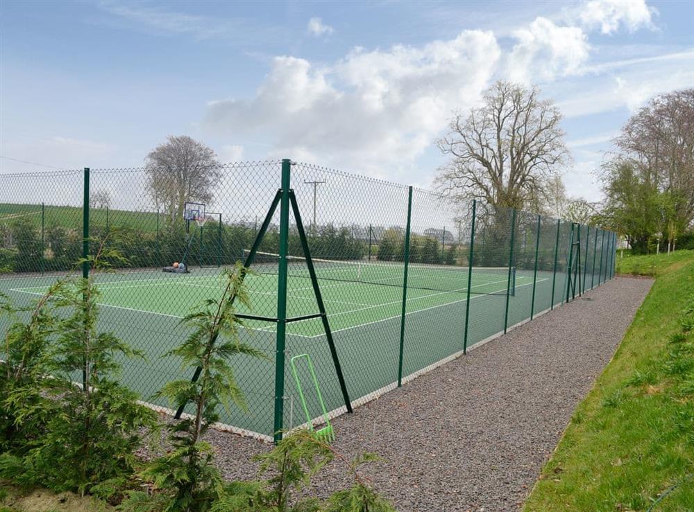 Shared all-weather tennis court at Grieves Cottage, 