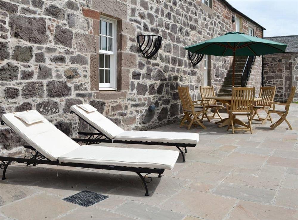 Patio area with outdoor furniture at The Stables, 