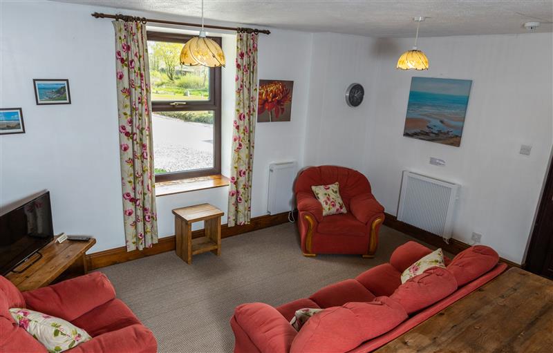 Relax in the living area at Old Nog Cottage, Torrington