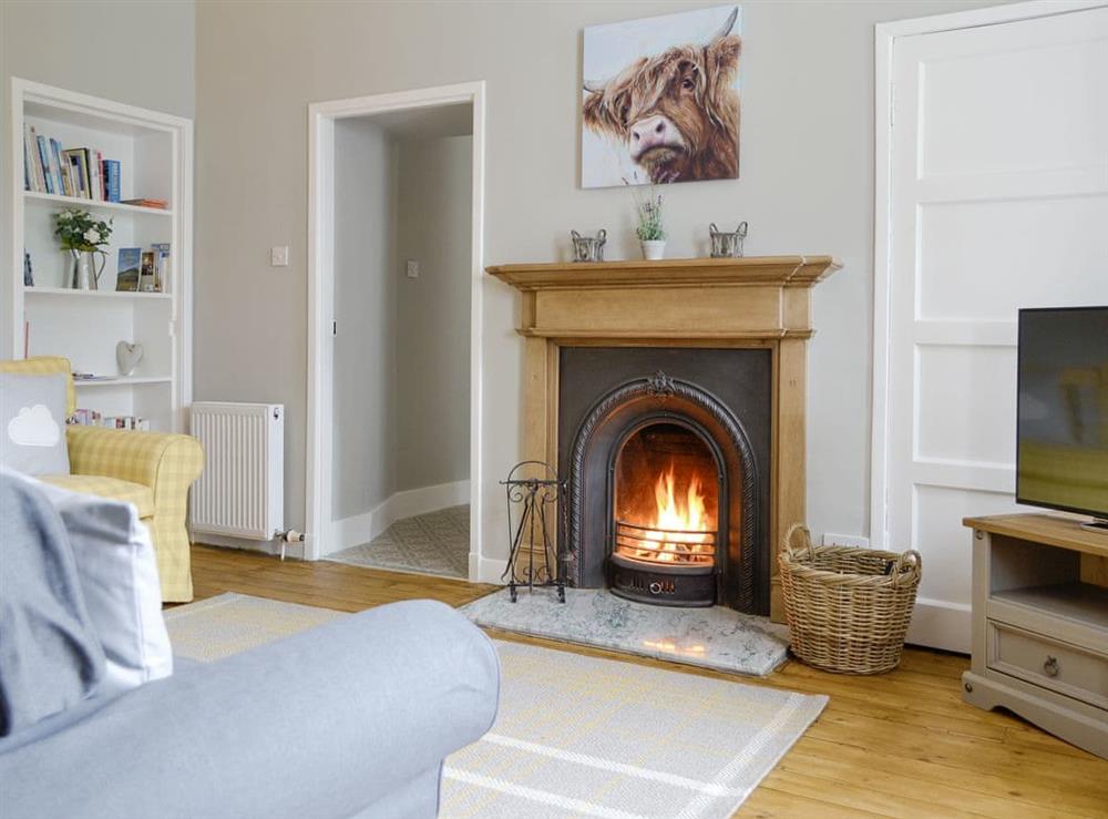 Welcoming living room with an open-fire at Old School Cottage in Kettins, near Blairgowrie, Perthshire