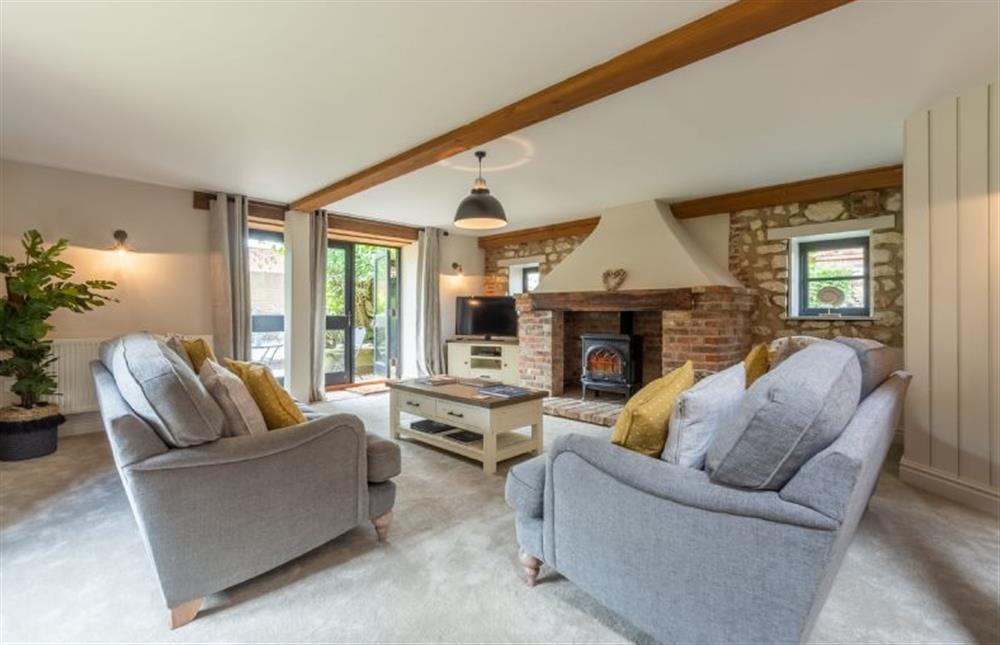 Ground Floor: Sitting room featuring a wood burning stove  at Old Smithy, Titchwell near Kings Lynn