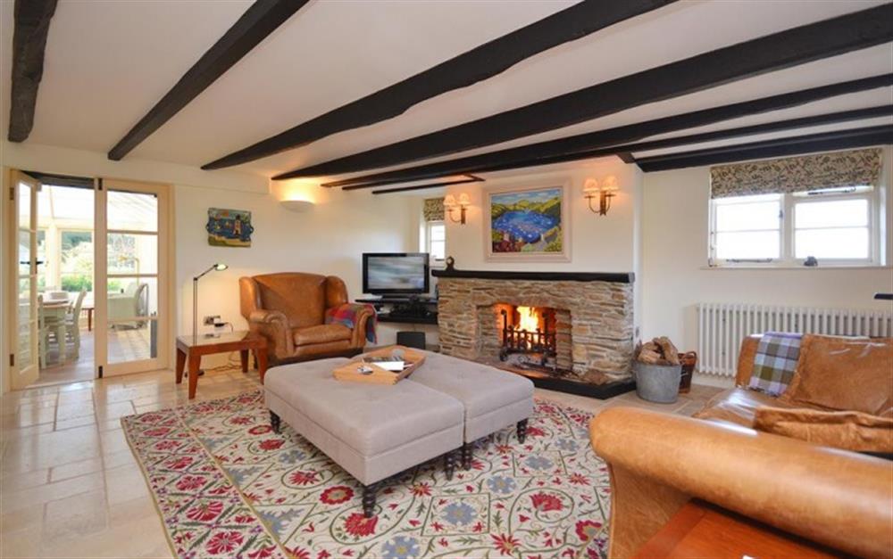 The cosy lounge looking towards the conservatory at Old Thatch in Torcross
