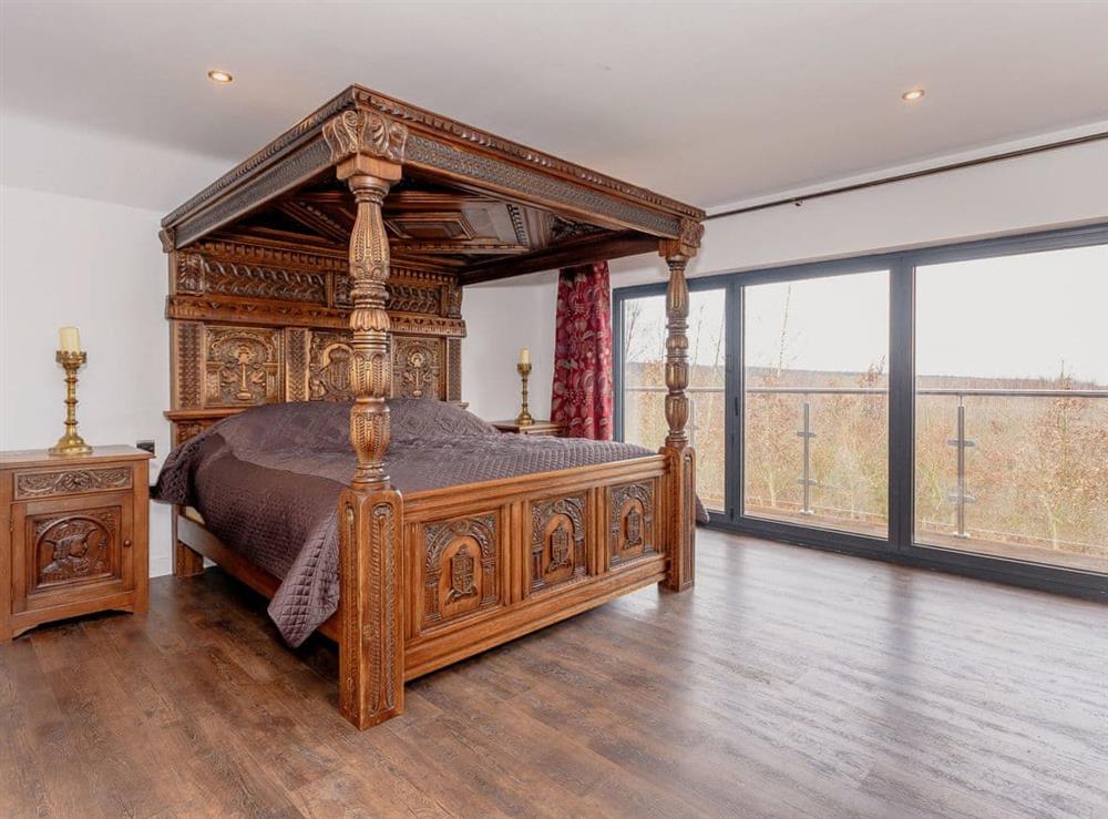 Relaxing en-suite four poster bedroom with balcony access at Olive Lodge in Melbourne, near Derby, Derbyshire