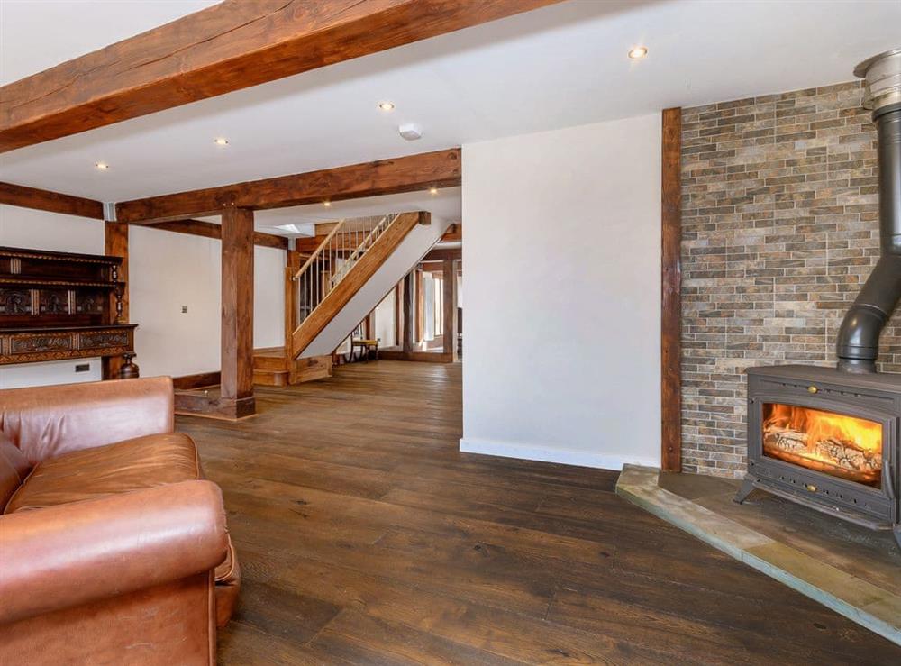 Welcoming living area with wood burner at Olive Lodge in Melbourne, near Derby, Derbyshire