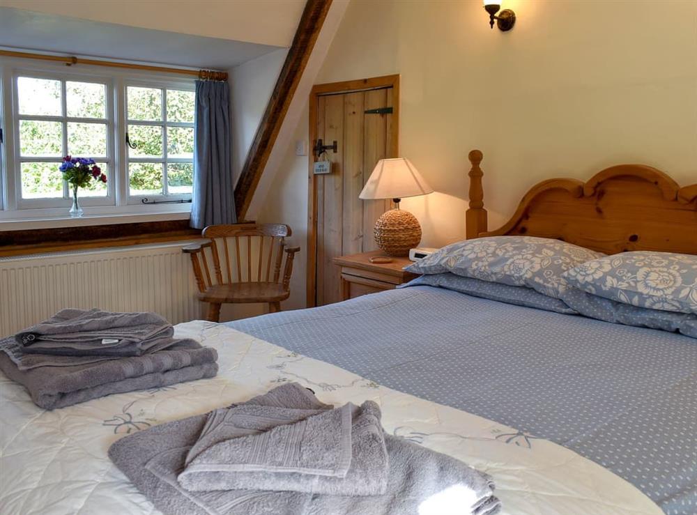 Relaxing double bedroom with beams at One Well Cottage in Holton, near Halesworth, Suffolk