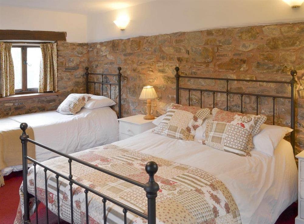 Spacious bedroom with one double and two single beds at Orchard Barn in Bampton, near Tiverton, Devon