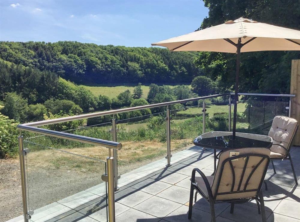 Patio with table and chairs overlooking the beautiful Cornish landscape at Orchard Close in Morwenstow, near Bude, Cornwall