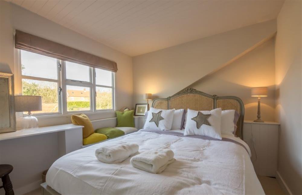 First floor: Bedroom two, king size bed and garden views at Orchard Cottage, Ringstead near Hunstanton