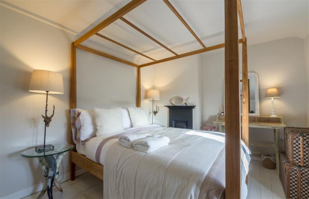 First floor: King size bedroom with four poster bed at Orchard Cottage, Ringstead near Hunstanton