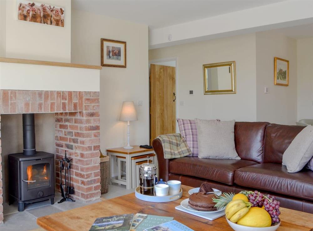 Delightful living room with cosy wood burner at Orchard Cottage in Upton Cressett, near Ironbridge, Shropshire
