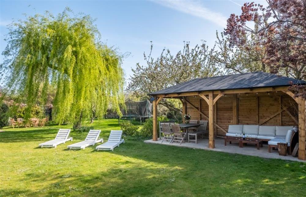 The summer house has plenty of outdoor seating at Orchard Cottage, Wells-next-the-Sea