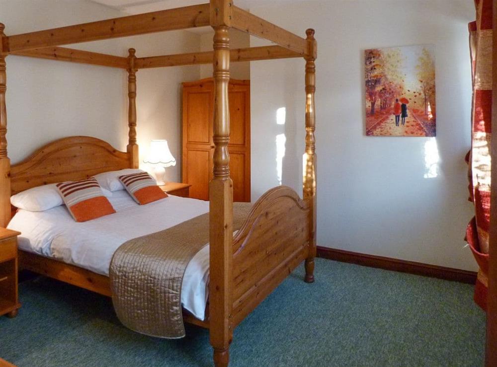 Relaxing four poster bed at Orchard Cottage in Wheddon Cross, Exmoor, Somerset