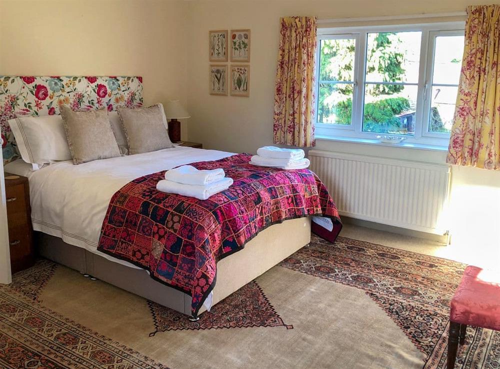 Cmfortable bedroom with kingsize bed at Orchard House in Hempstead, near Holt, Norfolk