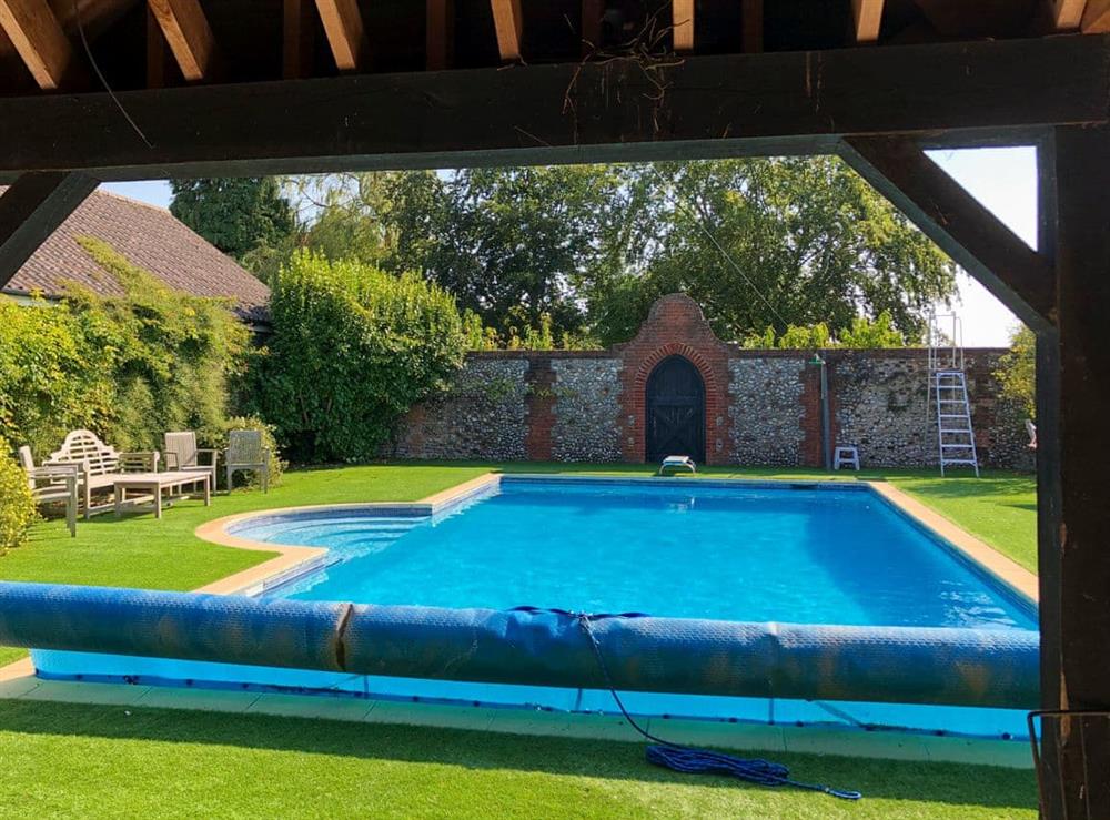 Shared outdoor heated swimming pool (photo 2) at Orchard House in Hempstead, near Holt, Norfolk