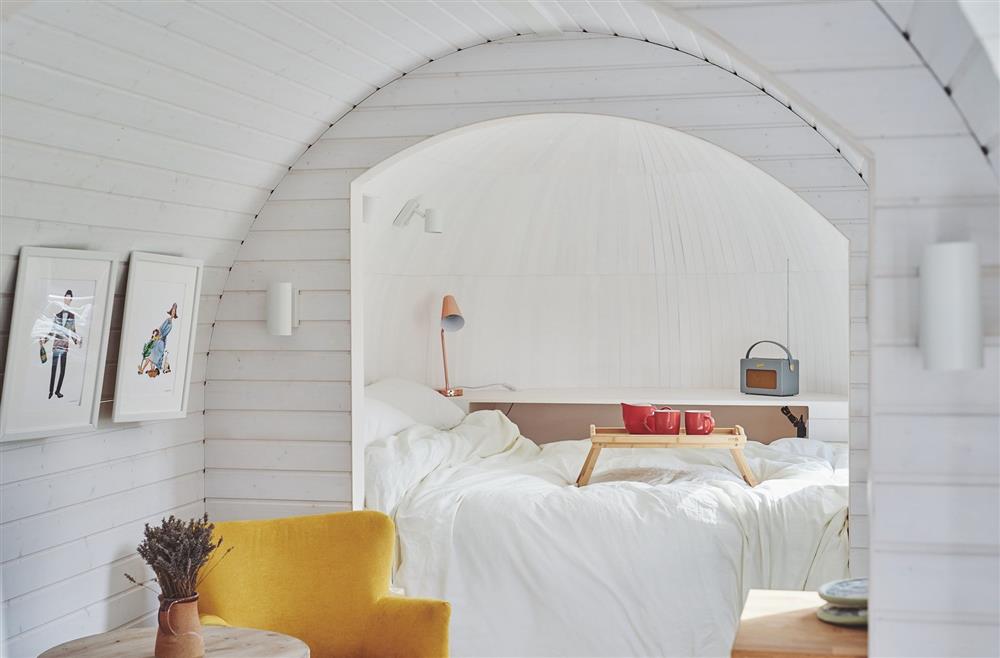 A yellow armchair and double bed