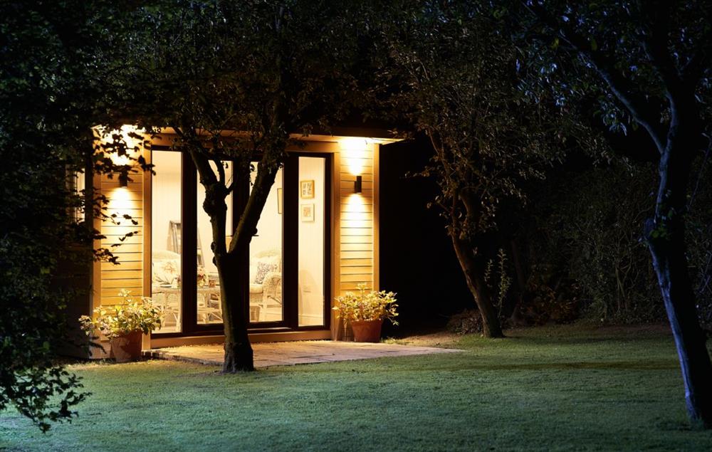 Beautiful lighting illuminates the summer house at night at Orchard View, Pulverbatch