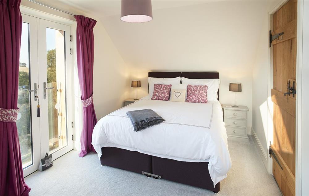 Bedroom with 5’ king size bed and en-suite bathroom at Orchard View, Pulverbatch