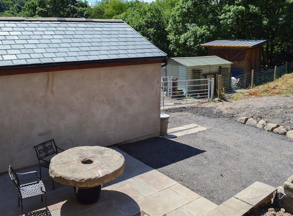 Private outdoor area with quirky table and chairs at Oriels Retreat in Ashworth Valley, near Bury, Lancashire