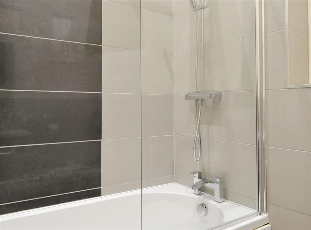 Family bathroom with shower over bath at Tarn Rigg Cottage, 